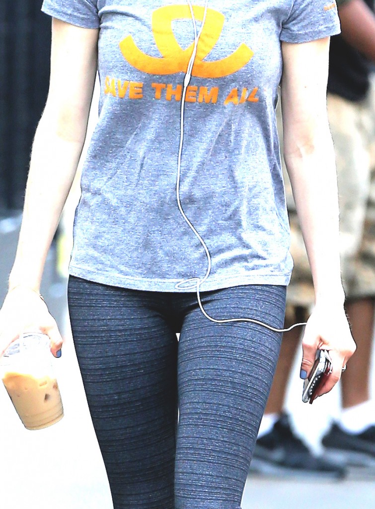 Actress Amanda Seyfried, wearing a 'Save Them All' t-shirt from Best Friends Animal Society, walks to the gym
