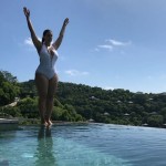 Ashley Graham fat in a one piece white bathing suit