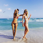 Doutzen Kroes in a Bikini on the beach with girlfriend