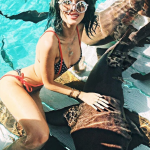 Bella Thorne in a bikini with a shark