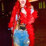 Bella Thorne in jeans and a red boa