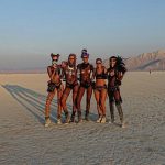 Candice Swanepoel and other models posing half naked at Burning Man