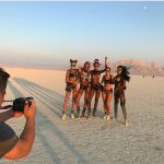 Candice Swanepoel and other models in leather and fish net at burning man