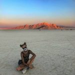 Candice Swanepoel knee deep in a sand storm in Nevada at Burning Man