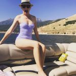 Hunger Games star Elizabeth Banks is enjoying Labor Day on a boat in a one piece swimsuit