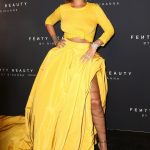 Rihanna at her make up release in a yellow see through top