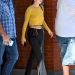 Selena Gomez no bra in a yellow sweater