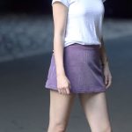 Selena Gomez white shirt purple skirt on set