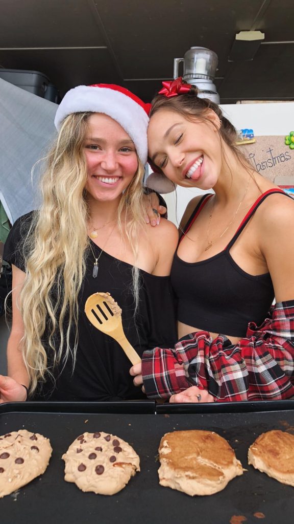 Alexis Ren in a black tank top tits out