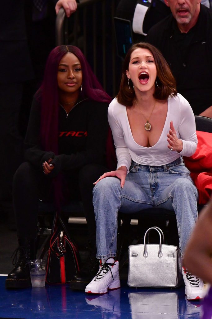 Bella Hadid shows off her cleavage in a tight white top at Basketball Game
