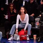 Bella Hadid sitting courtside at a basketball game