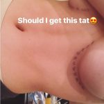Bella throne showing off her tattoos under her boobs