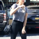 Elizabeth Olsen in a grey t shirt and black leggings
