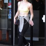Elle Fanning in tight black leggings and a sports bra