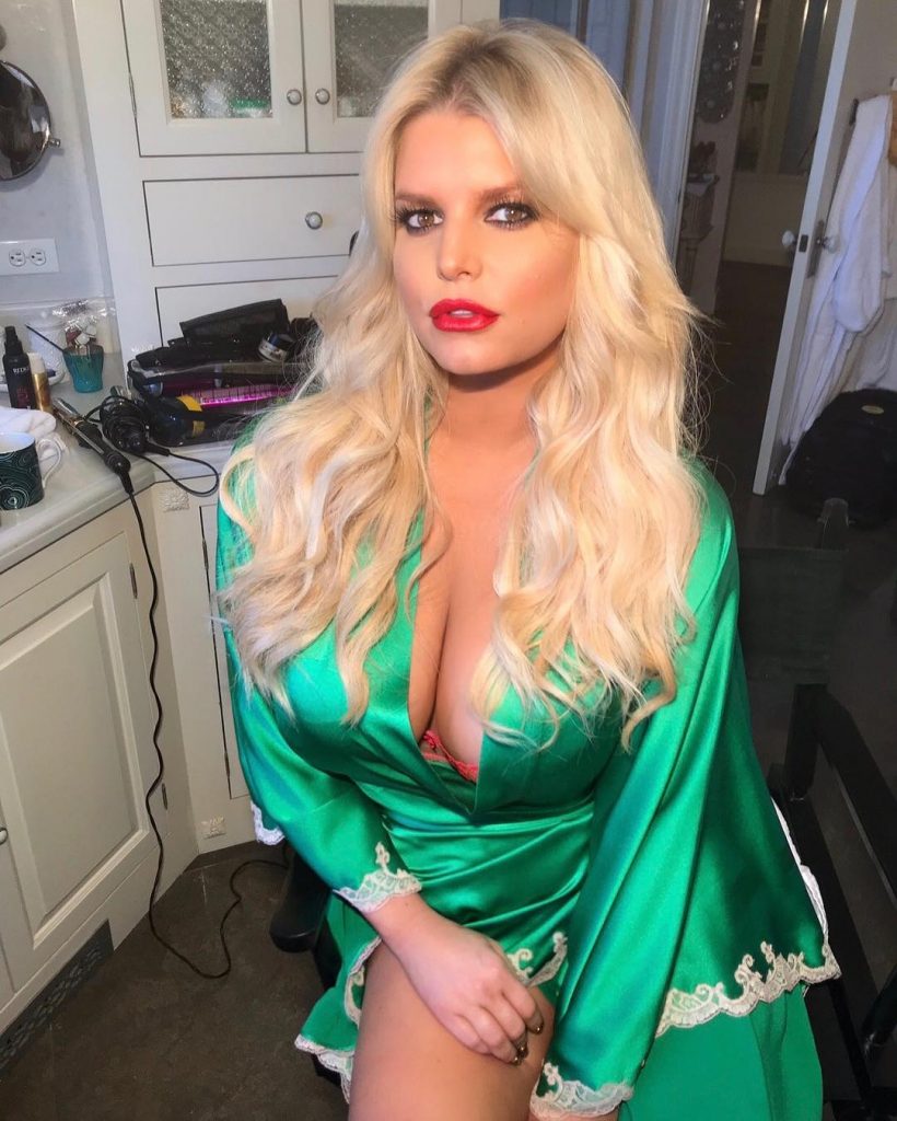 Jessica Simpson shows off her huge cleavage in a green silk robe