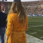 Jojo at a sports game in yellow velour pants and matching jacket