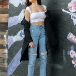 Madison Beer in ripped jeans and a white shirt