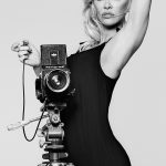 Pam Anderson Coco De Mer in a Black Dress Behind a Camera