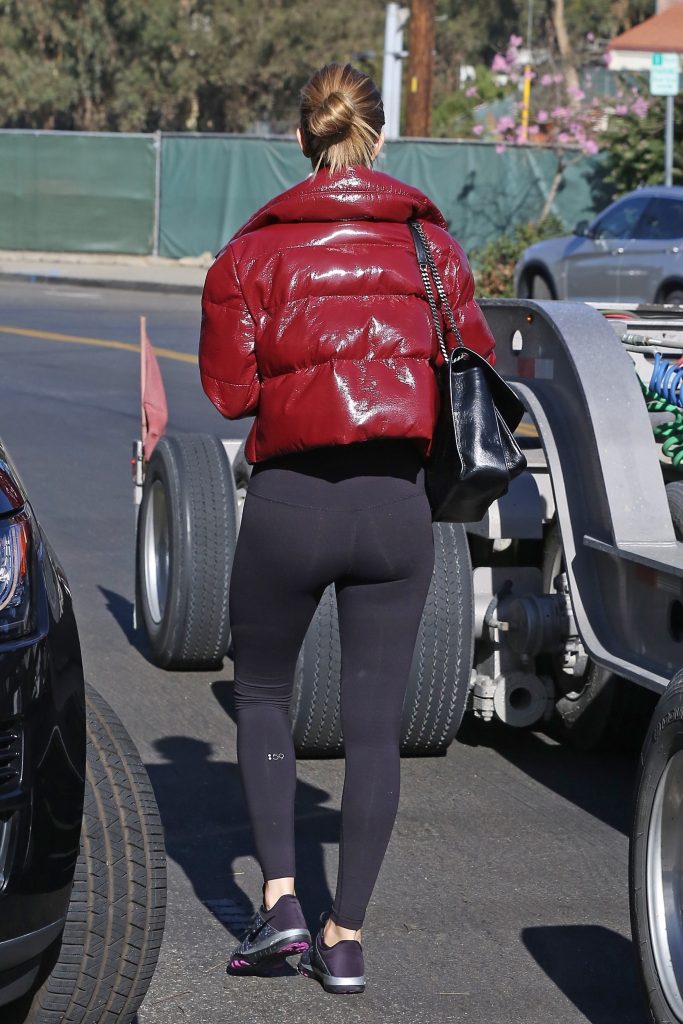 Rosie Huntington-Whitely in black leggings and a red jacket