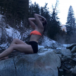 Scout Willis in the cold river in short shorts and a bikini top