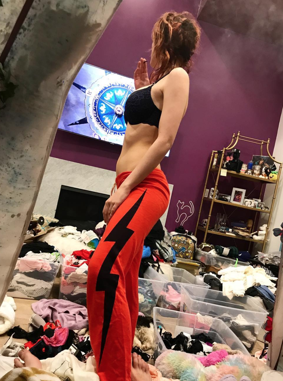 Bella Thorne stands in her own filth wearing a bra and smoking a blunt 