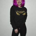 Bella Thorne in black sweater and pink wig