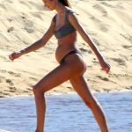 Candice Swanepoel walks around very pregnant on the beach