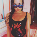 Demi Lovato in a black one piece swimsuit