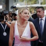 Margot Robbie in a lowcut pink dress showing cleavage