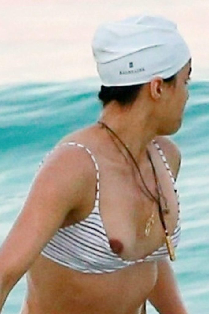 Michelle Rodriguez lets her nipple fall out of her bikini on the beach 