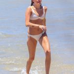 Miley Cyrus in a white bikini on the beach
