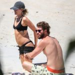Miley Cyrus strips down on the beach
