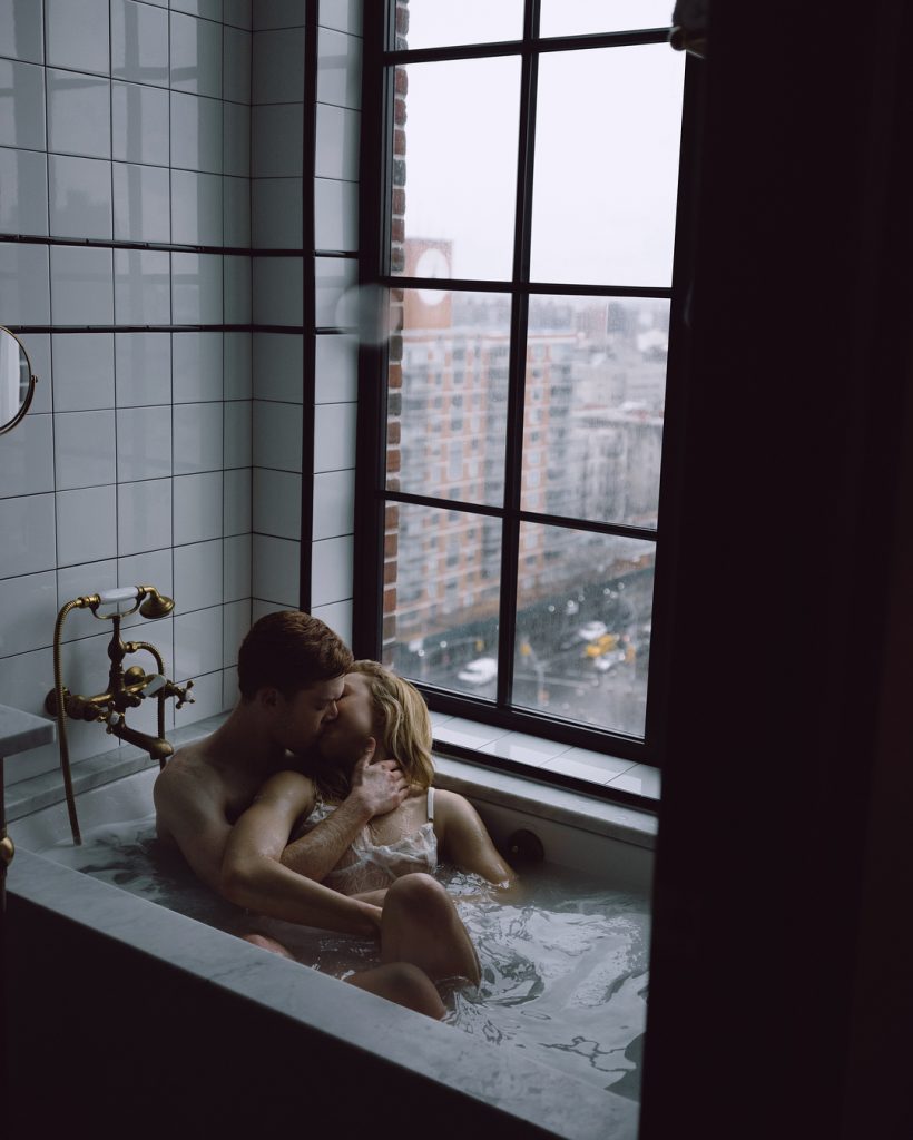 Peyton Roi making out with a man in a bathtub see through dress