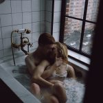 Peyton Roi making out with a man in a bathtub see through dress