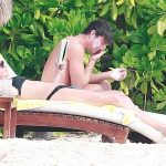 Rebecca Romijn lounging with jerry oconell in a black bikini