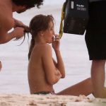 Rosie Huntington-Whiteley covers her tits on the beach