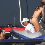 Sofia Richie Gets onto a boat in a swimsuit