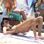 Alessandra Ambrosio pulls her thong out of her ass on the beach