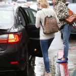 Emma Roberts gets into her car in Jeans