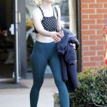 Elle Fanning in tight green leggings and a sports bra