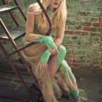Dakota Fanning on the stairs in a green and nude sequin dress