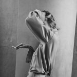 Eva Herzigova smoking in a silk dress
