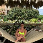 Lea Michele in a neon yellow bikini in a hammock