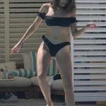 Olivia Culpo gets wet in a black thong bikini