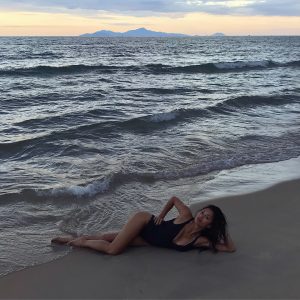 nicole scherzinger big fake tits in a black cut out bikini laying in the sand
